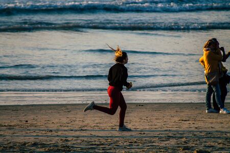 Tel Aviv Israel January 10, 2020 View of unidentified Israeli people having fun on the beach of Tel Aviv during a sunny day in winterの写真素材