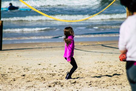 Tel Aviv Israel January 11, 2020 View of unidentified child having fun on the beach of Tel Aviv in winterの写真素材
