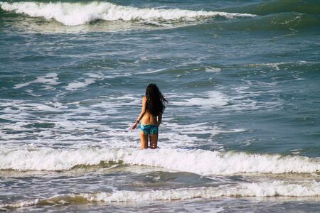 Tel Aviv Israel January 11, 2020 View of unidentified child having fun on the beach of Tel Aviv in winterの写真素材