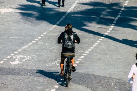 Tel Aviv Israel January 11, 2020 View of unidentified people rolling with a bicycle in the streets of Tel Aviv in winterの写真素材