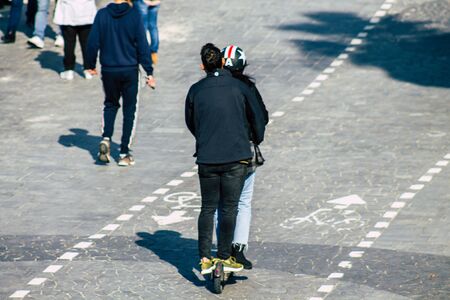 Tel Aviv Israel January 13, 2020 View of unidentified people rolling with an electric scooter in the streets of Tel Aviv in winterの写真素材