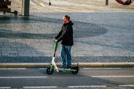 Tel Aviv Israel January 29, 2020 View of unidentified people rolling with an electric scooter in the streets of Tel Aviv in winterのeditorial素材