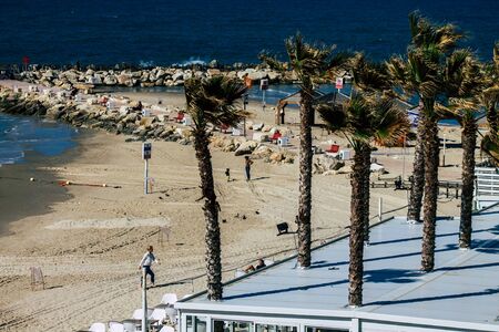 Tel Aviv Israel January 30, 2020 View of unidentified Israeli people having fun on the beach of Tel Aviv during a sunny day in winterの写真素材