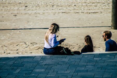 Tel Aviv Israel February 12, 2020 View of unidentified Israeli people having fun on the beach of Tel Aviv during a sunny day in winterの写真素材