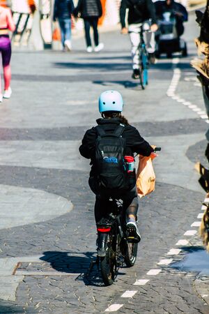 Tel Aviv Israel February 12, 2020 View of unidentified people rolling with a bicycle in the streets of Tel Aviv during a sunny day in winterの写真素材