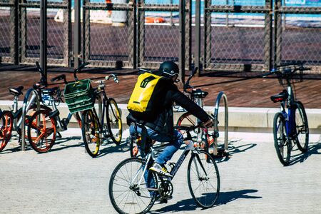 00211 Tel Aviv Israel February 13, 2020 View of unidentified people rolling with a bicycle in the streets of Tel Aviv during a sunny day in winterの写真素材