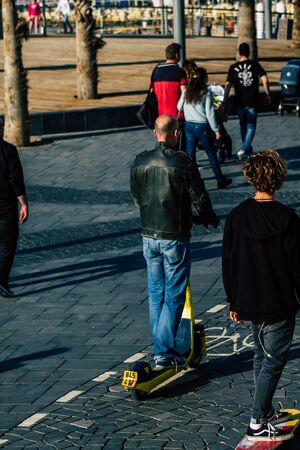 Tel Aviv Israel February 15, 2020 View of unidentified people rolling with an electric scooter in...