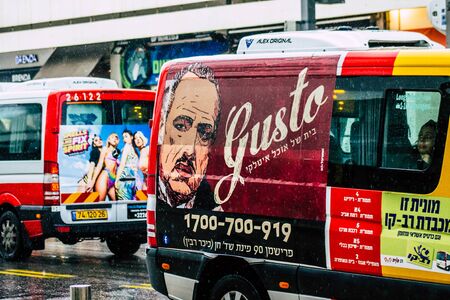 Tel Aviv Israel February 19, 2020 View of traditional Israeli taxi rolling in the streets of Tel Aviv during a raining day in winterの写真素材