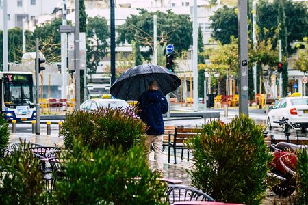 Tel Aviv Israel February 19, 2020 View of unidentified people walking in the streets of Tel Aviv during a raining day in winterの写真素材