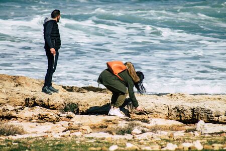 Paphos Cyprus March 01, 2020 View of unidentified people having fun on the beach of Paphos in the afternoonの写真素材