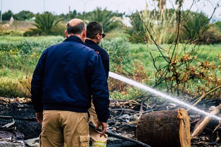 Paphos Cyprus March 04, 2020 View of a Cypriot firefighter putting out a brush fire near Paphosの写真素材