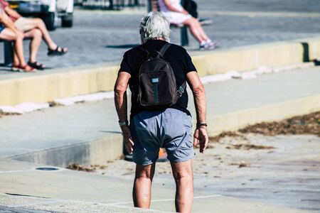 Paphos Cyprus March 10, 2020 View of unidentified tourist walking in the streets of Paphos in the afternoonの写真素材