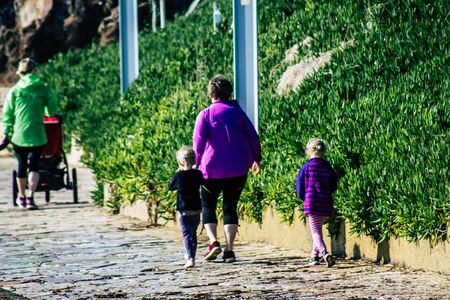 Paphos Cyprus March 10, 2020 View of unidentified tourist walking in the streets of Paphos in the afternoonの写真素材