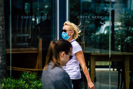 Limassol Cyprus March 16, 2020 View of an unidentified people with a face mask to protect themselves from the coronavirus walking in the street of Limassol in the afternoonのeditorial素材
