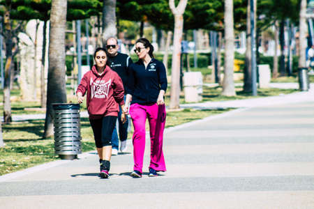 Limassol Cyprus March 16, 2020 View of an unidentified people without a face mask to protect themselves from the coronavirus walking in the street of Limassol in the afternoonのeditorial素材