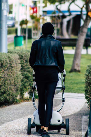 Limassol Cyprus March 16, 2020 View of an unidentified people without a face mask to protect themselves from the coronavirus walking in the street of Limassol in the afternoonのeditorial素材