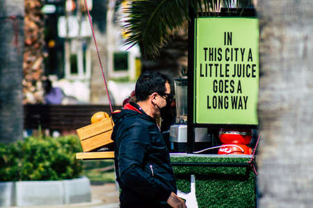 Limassol Cyprus March 16, 2020 View of an unidentified people with a face mask to protect themselves from the coronavirus walking in the street of Limassol in the afternoonのeditorial素材