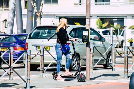 Limassol Cyprus March 19, 2020 View of unidentified people driving a electric scooter in the streets of Limassol in the afternoonの写真素材