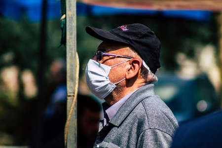 Limassol Cyprus March 14, 2020 View of an unidentified people with a face mask to protect themselves from the coronavirus shopping in the Limassol market in the morningのeditorial素材