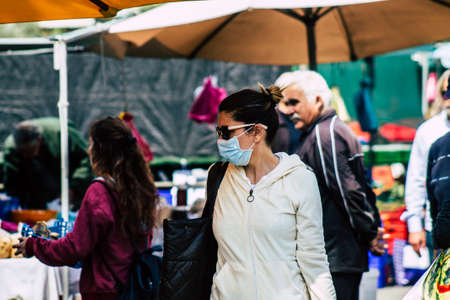 Limassol Cyprus March 14, 2020 View of an unidentified people with a face mask to protect themselves from the coronavirus shopping in the Limassol market in the morningのeditorial素材
