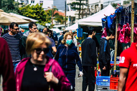 Limassol Cyprus March 14, 2020 View of an unidentified people with a face mask to protect themselves from the coronavirus shopping in the Limassol market in the morningのeditorial素材