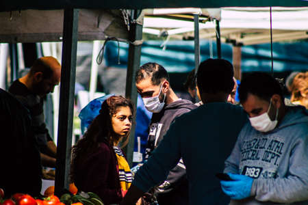 Limassol Cyprus March 14, 2020 View of an unidentified people with a face mask to protect themselves from the coronavirus shopping in the Limassol market in the morningのeditorial素材