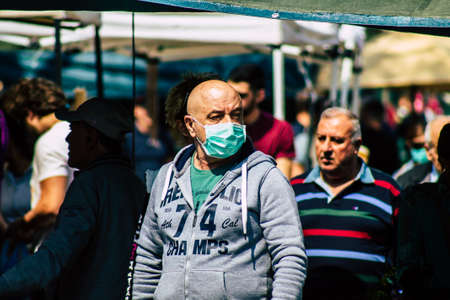 Limassol Cyprus March 14, 2020 View of an unidentified people with a face mask to protect themselves from the coronavirus shopping in the Limassol market in the morningのeditorial素材