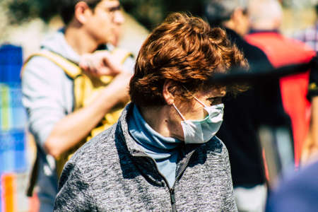 Limassol Cyprus March 14, 2020 View of an unidentified people with a face mask to protect themselves from the coronavirus shopping in the Limassol market in the morningのeditorial素材