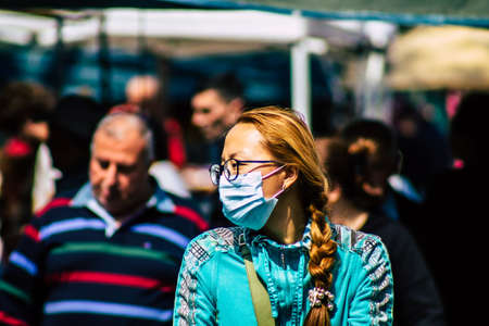 Limassol Cyprus March 14, 2020 View of an unidentified people with a face mask to protect themselves from the coronavirus shopping in the Limassol market in the morningのeditorial素材