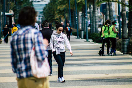 Limassol Cyprus March 16, 2020 View of an unidentified people without a face mask to protect themselves from the coronavirus walking in the street of Limassol in the afternoonのeditorial素材