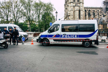 Paris France April 16, 2019 View of a French police car parked near the Notre Dame cathedral in Paris the day after the big fire in the afternoonのeditorial素材
