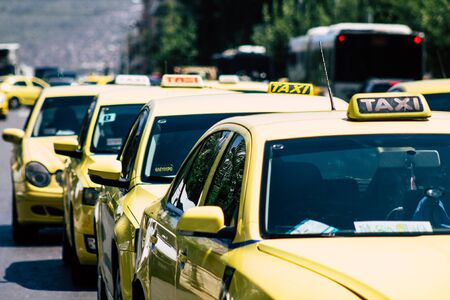 Athens Greece August 28, 2019 View of Greek yellow taxis rolling through the streets of Athens in the morningの写真素材