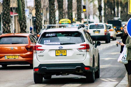 Tel Aviv Israel February 11, 2020 View of traditional Israeli taxi rolling in the streets of Tel Aviv in the afternoonの写真素材