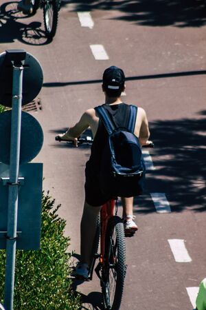 Limassol Cyprus May 10, 2020 View of unidentfied people rolling with a bicycle in the streets of...