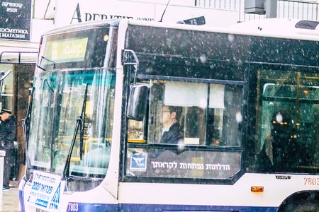 Tel Aviv Israel February 19, 2020 View of a traditional Israeli public city bus rolling in the streets of Tel Aviv during a raining day in winterの写真素材