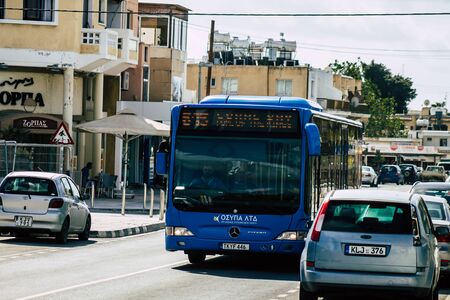 Paphos Cyprus February 29, 2020 View of a traditional public bus rolling in the streets of Paphos in the afternoonの写真素材