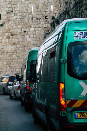 Jerusalem Israel December 17, 2019 View of a traditional Israeli public city bus rolling in the streets of Jerusalem in the afternoonの写真素材