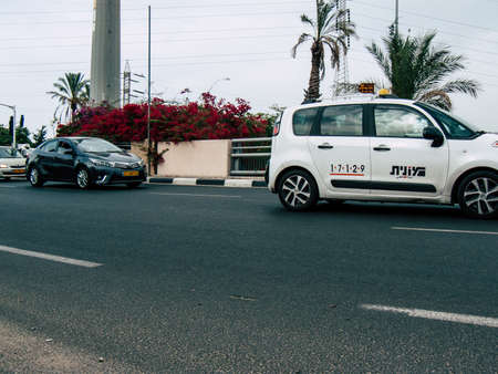 Tel Aviv Israel October 23, 2018  View of a traditional Israeli white taxi in the street of Tel Aviv in the afternoonのeditorial素材