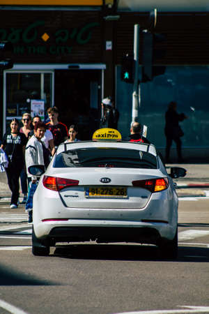 Tel Aviv Israel February 20, 2020 View of traditional Israeli taxi rolling in the streets of Tel Aviv during a sunny day in winterのeditorial素材
