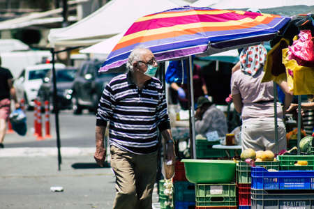 Limassol Cyprus May 09, 2020 View of an unidentified people with a face mask to protect themselves from the coronavirus shopping in the Limassol market in the morningのeditorial素材