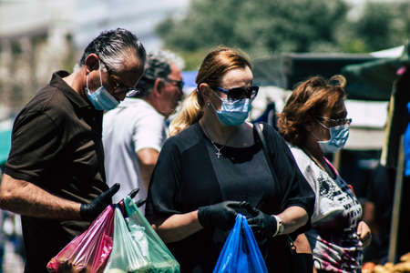 Limassol Cyprus May 09, 2020 View of an unidentified people with a face mask to protect themselves from the coronavirus shopping in the Limassol market in the morningのeditorial素材