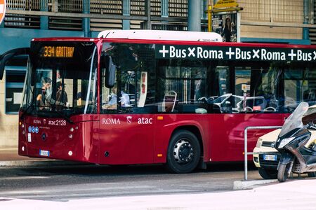 Rome Italy September 15, 2019 View of a red public bus rolling through the streets of Rome in the morningの写真素材