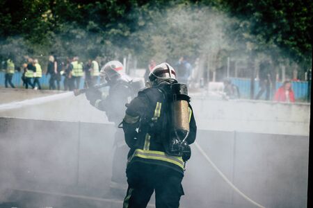 Reims France May 18, 2019 View of firefighters extinguishing a construction hut burned by rioters during protests of the Yellow Jackets in the streets of Reims on saturday afternoonの写真素材