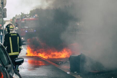 Reims France May 18, 2019 View of firefighters extinguishing a construction hut burned by rioters during protests of the Yellow Jackets in the streets of Reims on saturday afternoonの写真素材