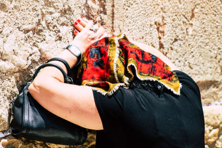 Jerusalem Israel June 24, 2019 View of unknown Israeli woman praying at the Western wall in the Old city of Jerusalem in the afternoonのeditorial素材