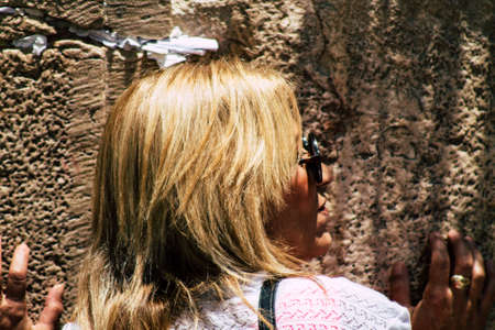 Jerusalem Israel June 24, 2019 View of unknown Israeli woman praying at the Western wall in the Old city of Jerusalem in the afternoonのeditorial素材