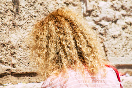 Jerusalem Israel June 24, 2019 View of unknown Israeli woman praying at the Western wall in the Old city of Jerusalem in the afternoonのeditorial素材