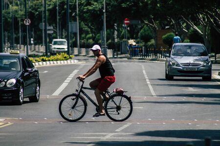 Limassol Cyprus May 21, 2020 View of unidentfied people rolling with a bicycle in the streets of...