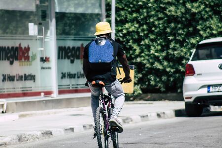 Limassol Cyprus May 21, 2020 View of unidentfied people rolling with a bicycle in the streets of Limassol in the afternoonの写真素材