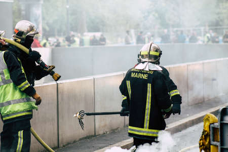Reims France May 18, 2019 View of firefighters extinguishing a construction hut burned by rioters during protests of the Yellow Jackets in the streets of Reims on saturday afternoonのeditorial素材